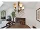 Dining room featuring a fireplace and views of the outdoor landscape at 3151 Landmark Dr # 123, Clearwater, FL 33761
