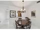 Bright dining room featuring an elegant chandelier and view into the updated kitchen at 3151 Landmark Dr # 123, Clearwater, FL 33761