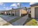 Exterior of condo featuring attached garages, walkway, and tropical landscaping under sunny skies at 3151 Landmark Dr # 123, Clearwater, FL 33761