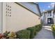 Condo entrance featuring unit numbers, a well-kept walkway, and tropical shrubbery at 3151 Landmark Dr # 123, Clearwater, FL 33761