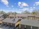 A lovely view of the exterior featuring an attractive two-story building with garages and beautiful tropical landscaping at 3151 Landmark Dr # 123, Clearwater, FL 33761