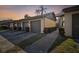 Exterior of condo featuring attached garages, walkway, and tropical landscaping at dusk at 3151 Landmark Dr # 123, Clearwater, FL 33761