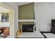 Modern fireplace design with tile surround and olive green accent wall at 3151 Landmark Dr # 123, Clearwater, FL 33761
