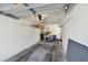 Garage interior featuring storage shelves, and a garage door opener at 3151 Landmark Dr # 123, Clearwater, FL 33761