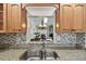Open concept kitchen with granite countertops and stainless steel sink overlooking the living area at 3151 Landmark Dr # 123, Clearwater, FL 33761