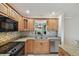Updated kitchen featuring granite countertops, mosaic backsplash, and stainless steel appliances at 3151 Landmark Dr # 123, Clearwater, FL 33761