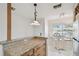 Eat-in kitchen featuring granite countertops, breakfast bar, and lots of natural light at 3151 Landmark Dr # 123, Clearwater, FL 33761
