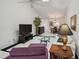 Comfortable living area with vaulted ceiling, large TV, and view of dining room at 3151 Landmark Dr # 123, Clearwater, FL 33761