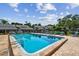 Community pool featuring lounge chairs and a tanning ledge at 3151 Landmark Dr # 123, Clearwater, FL 33761
