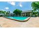 Community pool featuring lounge chairs and a covered area with tables and chairs at 3151 Landmark Dr # 123, Clearwater, FL 33761