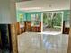 Bright living room with tiled floors and windows overlooking the backyard, ideal for indoor-outdoor living at 346 80Th Ne Ave, St Petersburg, FL 33702