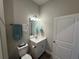 Cozy bathroom featuring a modern sink with mirror, and a white toilet at 493 Omen St, Punta Gorda, FL 33982