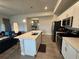 Bright kitchen with white cabinets, stainless steel appliances, and island with seating area at 493 Omen St, Punta Gorda, FL 33982