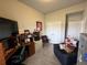 Home office features an L-shaped desk, a comfortable armchair, and ample storage space at 493 Omen St, Punta Gorda, FL 33982