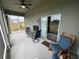 Relaxing screened patio furnished with chairs and a table, perfect for outdoor enjoyment at 493 Omen St, Punta Gorda, FL 33982
