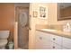 Well-lit bathroom featuring a glass-enclosed shower, toilet, and a vanity with a sink and storage at 5565 Salem Square N Dr, Palm Harbor, FL 34685