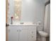 Bright bathroom features a white vanity, toilet, and neutral-toned decor at 5565 Salem Square N Dr, Palm Harbor, FL 34685