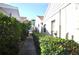 Well maintained exterior view of the property's side and landscaping at 5565 Salem Square N Dr, Palm Harbor, FL 34685
