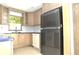 Bright kitchen features modern appliances, natural wood cabinets, and granite countertops at 5565 Salem Square N Dr, Palm Harbor, FL 34685