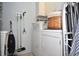 Bright laundry room is equipped with washer, dryer, and storage for convenience at 5565 Salem Square N Dr, Palm Harbor, FL 34685