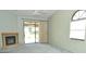 Bright living room with fireplace and sliding doors opening to the outside patio at 5565 Salem Square N Dr, Palm Harbor, FL 34685