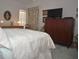 A classic main bedroom is enhanced with decorative touches and ample natural light at 5565 Salem Square N Dr, Palm Harbor, FL 34685