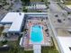 Aerial community pool and lounge area with lounge chairs, tables, and a parking area at 117 S Saint Thomas Cir, Apollo Beach, FL 33572