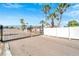 Gated community entrance with black metal fence, manicured landscaping and lush palm trees at 117 S Saint Thomas Cir, Apollo Beach, FL 33572