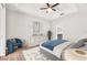 Cozy bedroom featuring a tray ceiling, ceiling fan, and stylish decor at 11811 Meadowgate Pl, Bradenton, FL 34211