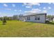 Expansive backyard with lush green lawn and home exterior view at 1226 Kazaz Ct, Zephyrhills, FL 33540