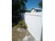 View of the backyard featuring a tall white fence and a small palm tree at 2835 Freemont S Ter, St Petersburg, FL 33712
