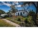 Backyard of a charming home featuring a custom wood deck and fenced yard at 2835 Freemont S Ter, St Petersburg, FL 33712