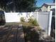 Well-maintained backyard features a new white fence and a small wooden deck at 2835 Freemont S Ter, St Petersburg, FL 33712