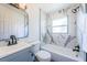 Modern bathroom features a tub with shower and large-format marble-look tile at 2835 Freemont S Ter, St Petersburg, FL 33712