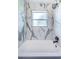 Close up on tub, with white and gray marbled tile and rainfall shower head at 2835 Freemont S Ter, St Petersburg, FL 33712
