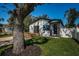 Charming home with a well-manicured lawn, stone columned entryway, and inviting wooden deck at 2835 Freemont S Ter, St Petersburg, FL 33712