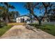 Charming home with a well-manicured lawn, stone columned entryway, and inviting wooden deck at 2835 Freemont S Ter, St Petersburg, FL 33712