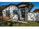 Charming home with a well-manicured lawn, stone columned entryway, and inviting wooden deck at 2835 Freemont S Ter, St Petersburg, FL 33712