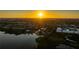 Panoramic aerial view of a residential community by the water at sunset, showcasing the neighborhood's serene setting at 10532 94Th Pl, Seminole, FL 33772