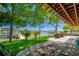 Charming backyard patio with lush landscaping and a serene view of the lake and dock perfect for relaxing outdoors at 10532 94Th Pl, Seminole, FL 33772