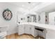 Bright bathroom features a long vanity with a large mirror and gold-tone hardware at 10532 94Th Pl, Seminole, FL 33772