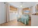 Bright bedroom with large windows with bamboo blinds and white wood paneling at 10532 94Th Pl, Seminole, FL 33772