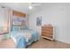 Charming bedroom featuring white shiplap walls and a stylish wood and white dresser at 10532 94Th Pl, Seminole, FL 33772