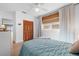 Bright bedroom with closet, a large window with bamboo blind and white wood paneling at 10532 94Th Pl, Seminole, FL 33772