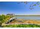 Private dock featuring a covered area extending into a calm body of water at 10532 94Th Pl, Seminole, FL 33772