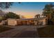 Charming single-story home with a well-manicured lawn and classic curb appeal at dusk at 10532 94Th Pl, Seminole, FL 33772