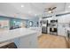 Updated kitchen features stainless steel appliances and white cabinetry at 10532 94Th Pl, Seminole, FL 33772