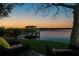 Relaxing lake view features a dock and seating area for enjoying the waterfront at 10532 94Th Pl, Seminole, FL 33772