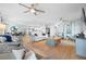 Open-concept living room with stylish decor, ceiling fans, and seamless flow into the dining area and kitchen at 10532 94Th Pl, Seminole, FL 33772
