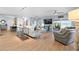 Spacious living room with wood floors, neutral colors, and sliding glass doors leading to outdoor living space at 10532 94Th Pl, Seminole, FL 33772